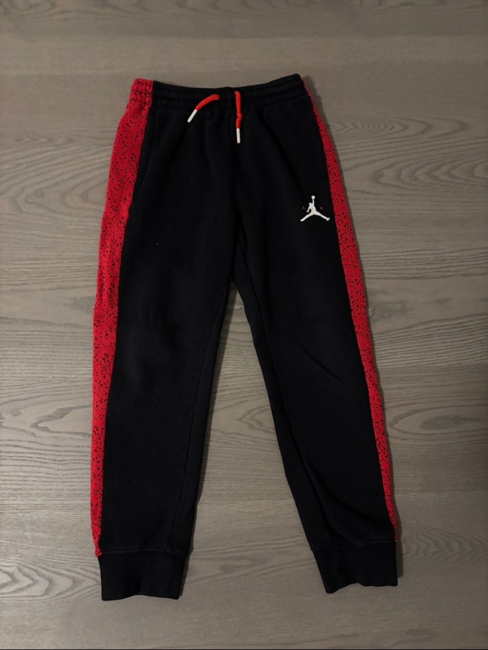 Jordan Black Joggers with Red Side Panels small stains on back